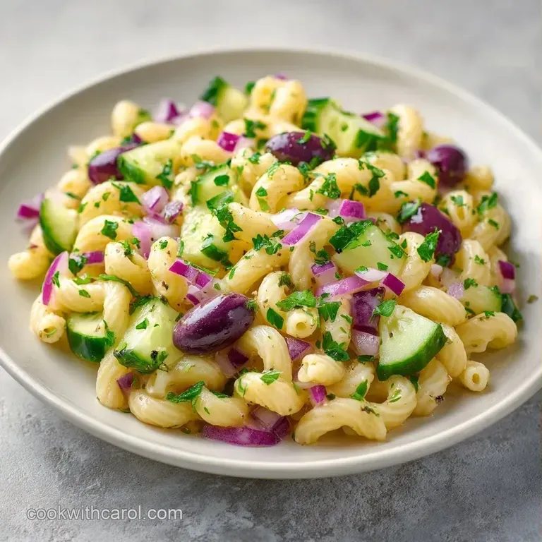 A wide ceramic platter of creamy pasta topped with thin lemon wheels, cracked pepper, and vibrant green basil leaves.