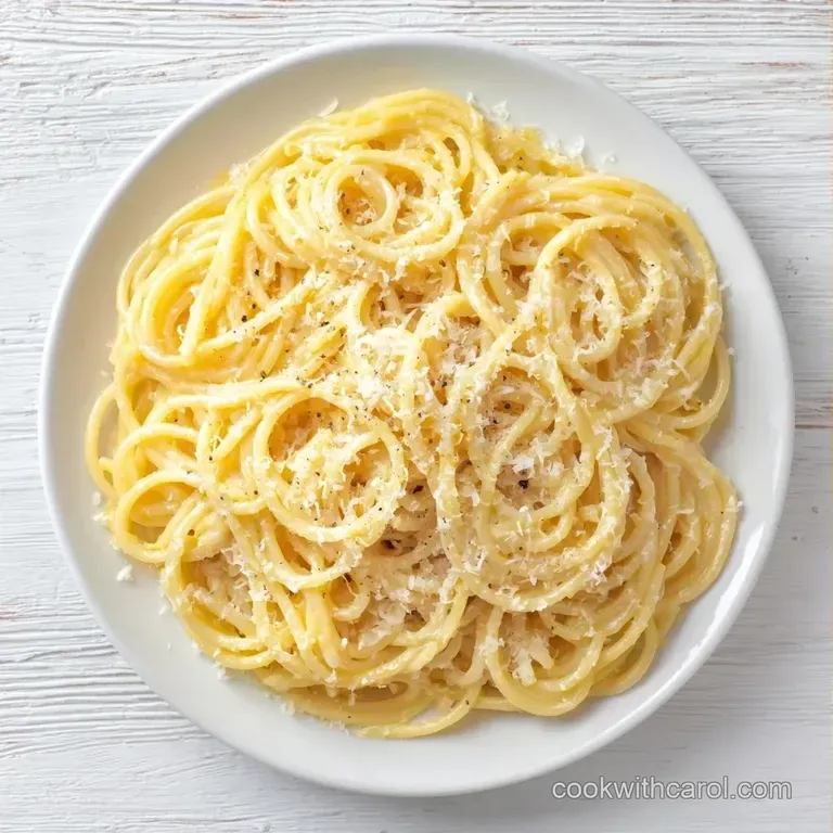 Twirled pasta on a matte white plate, topped with snow-white cheese shavings and a sprig of fresh emerald basil.